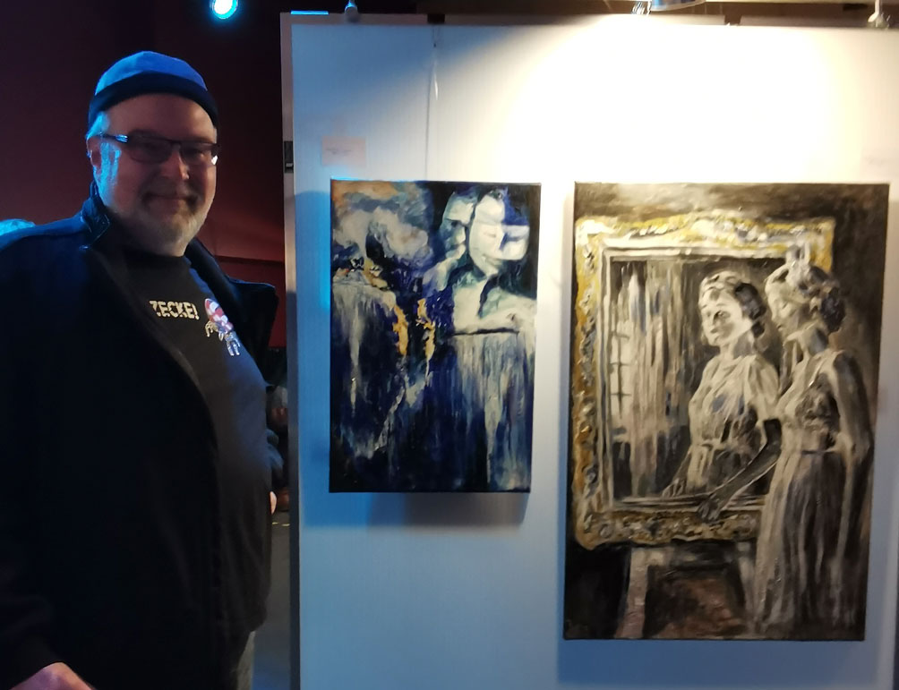 Andreas Wick next to two of his images at ArtFest2025